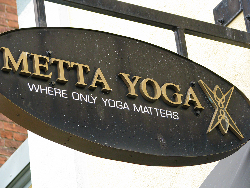metta yoga projecting sign