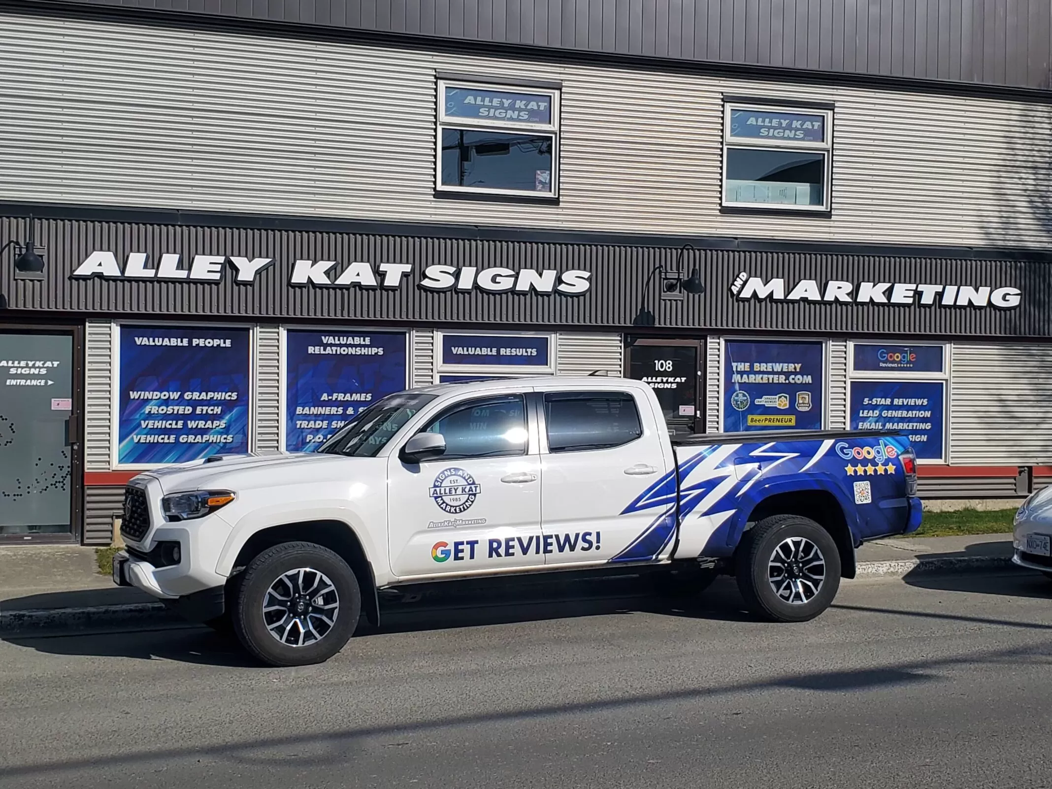 Alley Kat Marketing truck parked outside the Alley Kat Signs and Marketing building